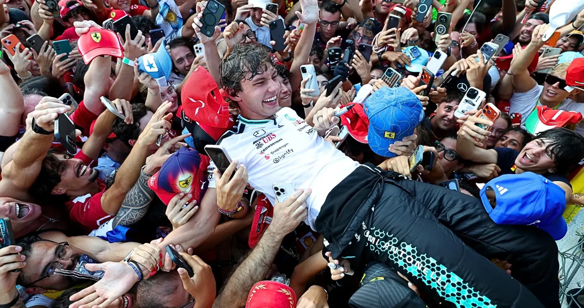 Piloto rodeado de aficionados tras la carrera