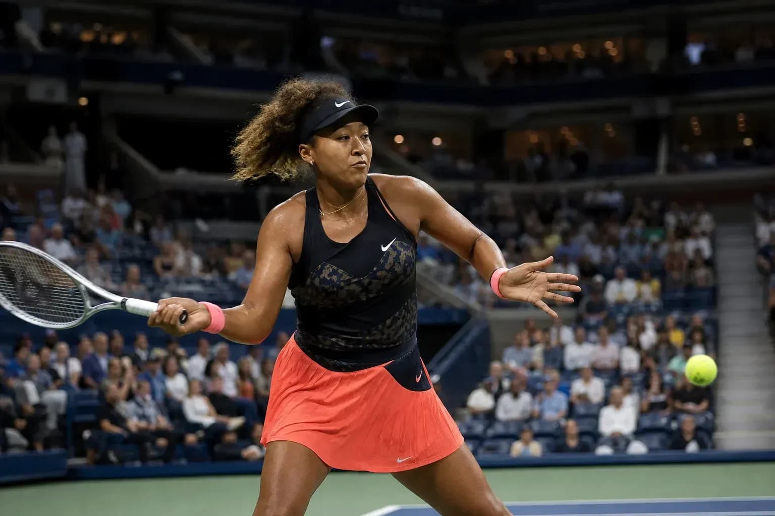 Naomi Osaka golpeando la pelota en la cancha