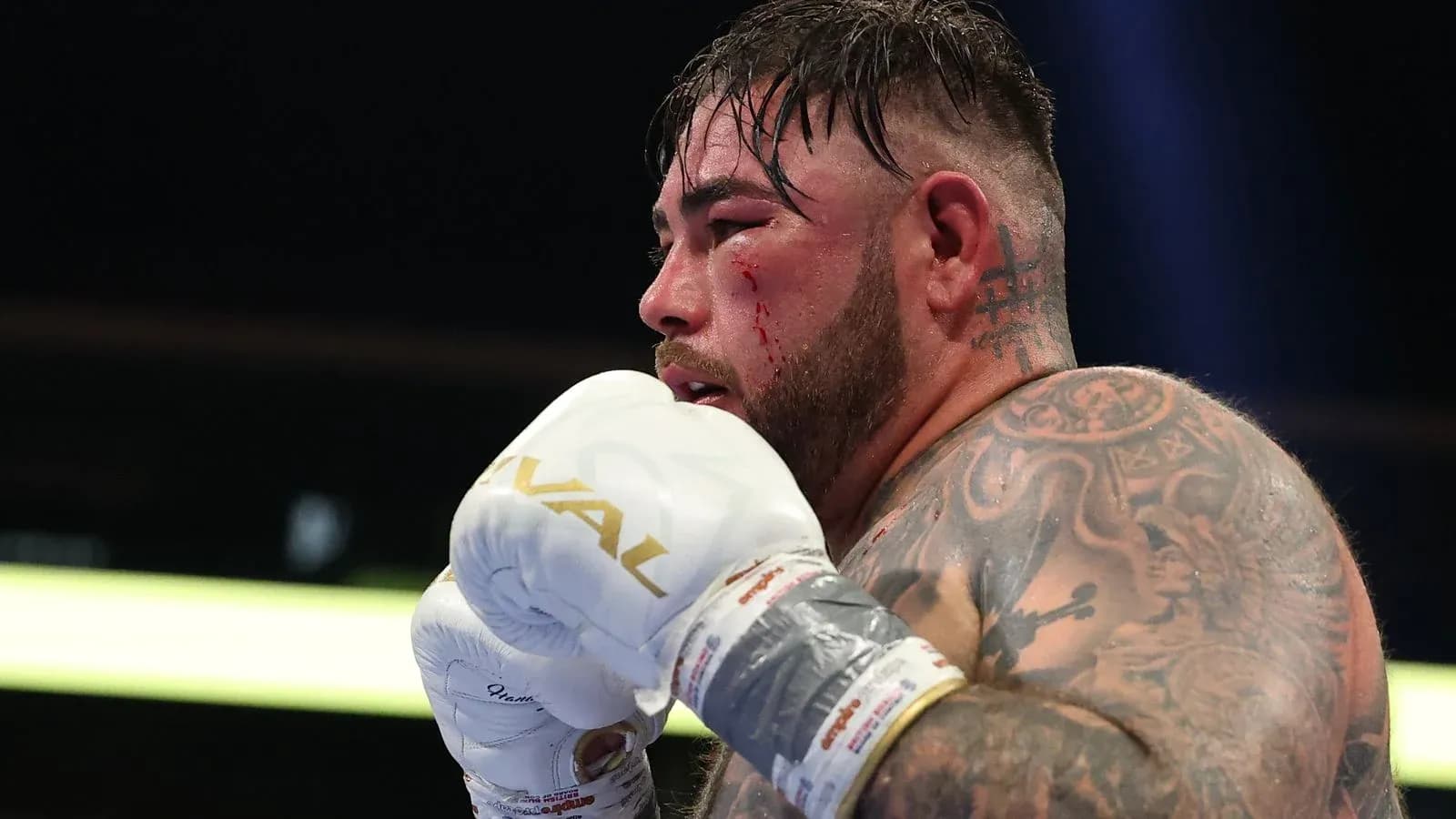 Boxeador con guantes, mostrando un corte en la cara