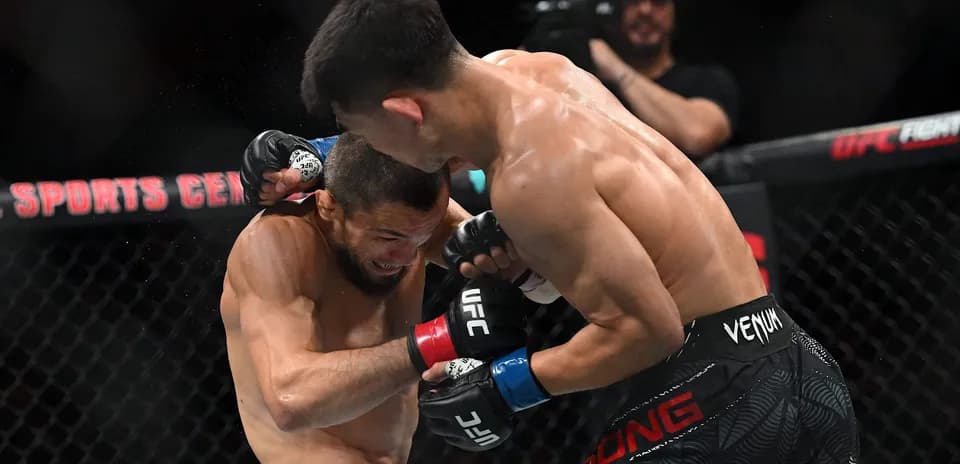 Peleadores intercambiando golpes en combate de UFC