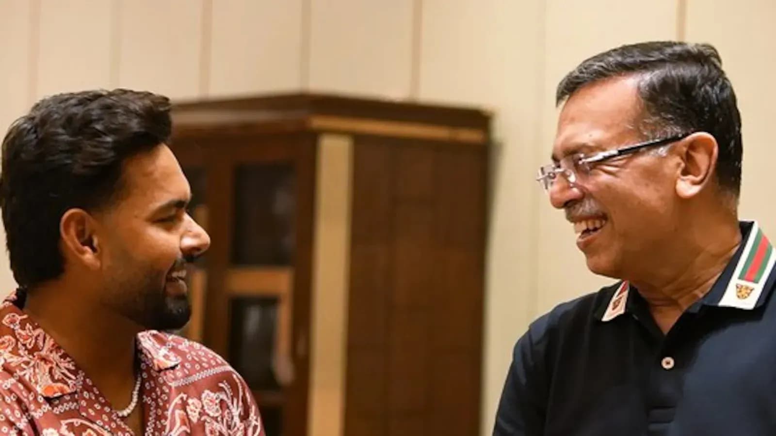 Dos personas sonriendo y conversando en interiores