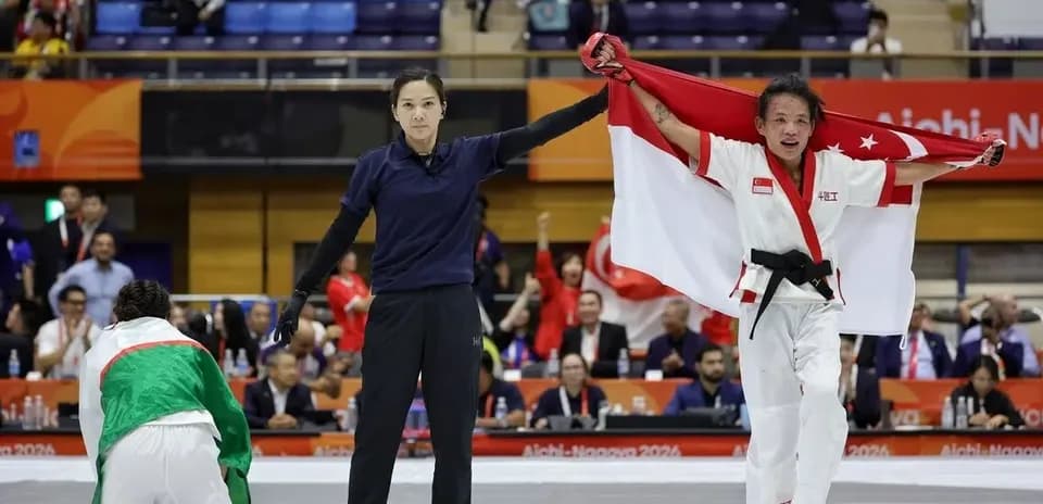 Competitor celebrating victory with Singapore flag