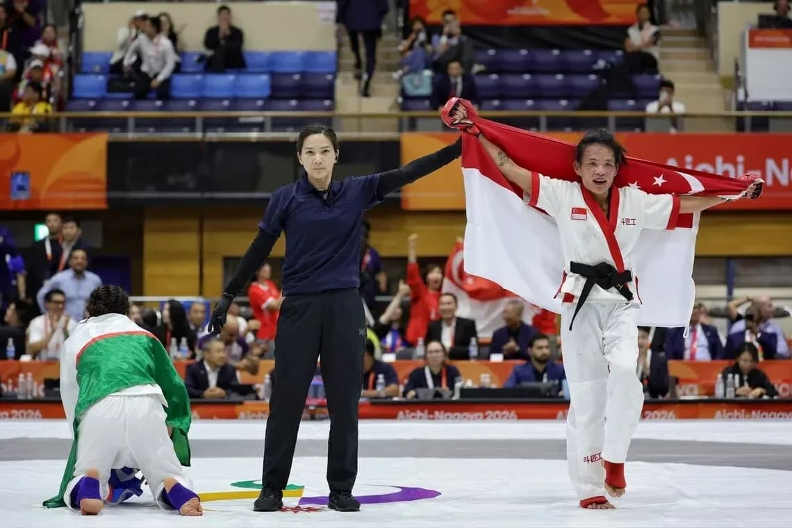 Competitor celebrating victory with Singapore flag
