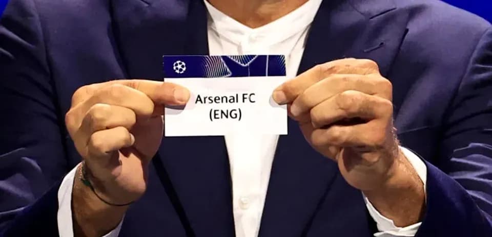 Persona sosteniendo tarjeta de Arsenal FC (ENG)