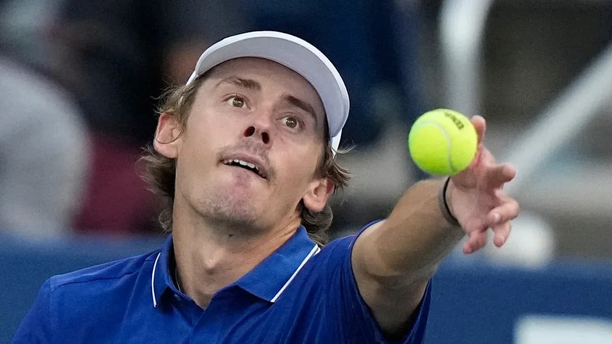 Jugador de tenis lanzando una pelota al servicio