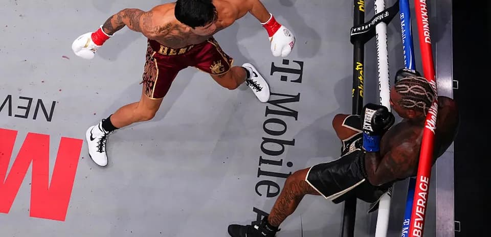 Boxer throwing a punch at opponent in ring