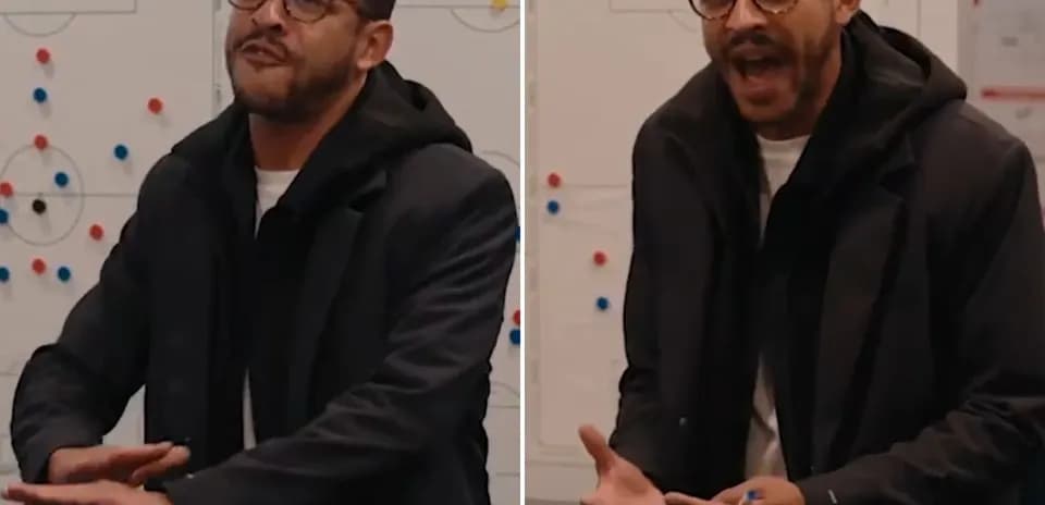 Entrenador hablando en pizarra táctica durante reunión