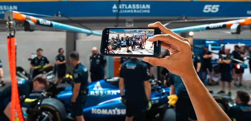 Persona tomando foto del equipo Williams en el pit