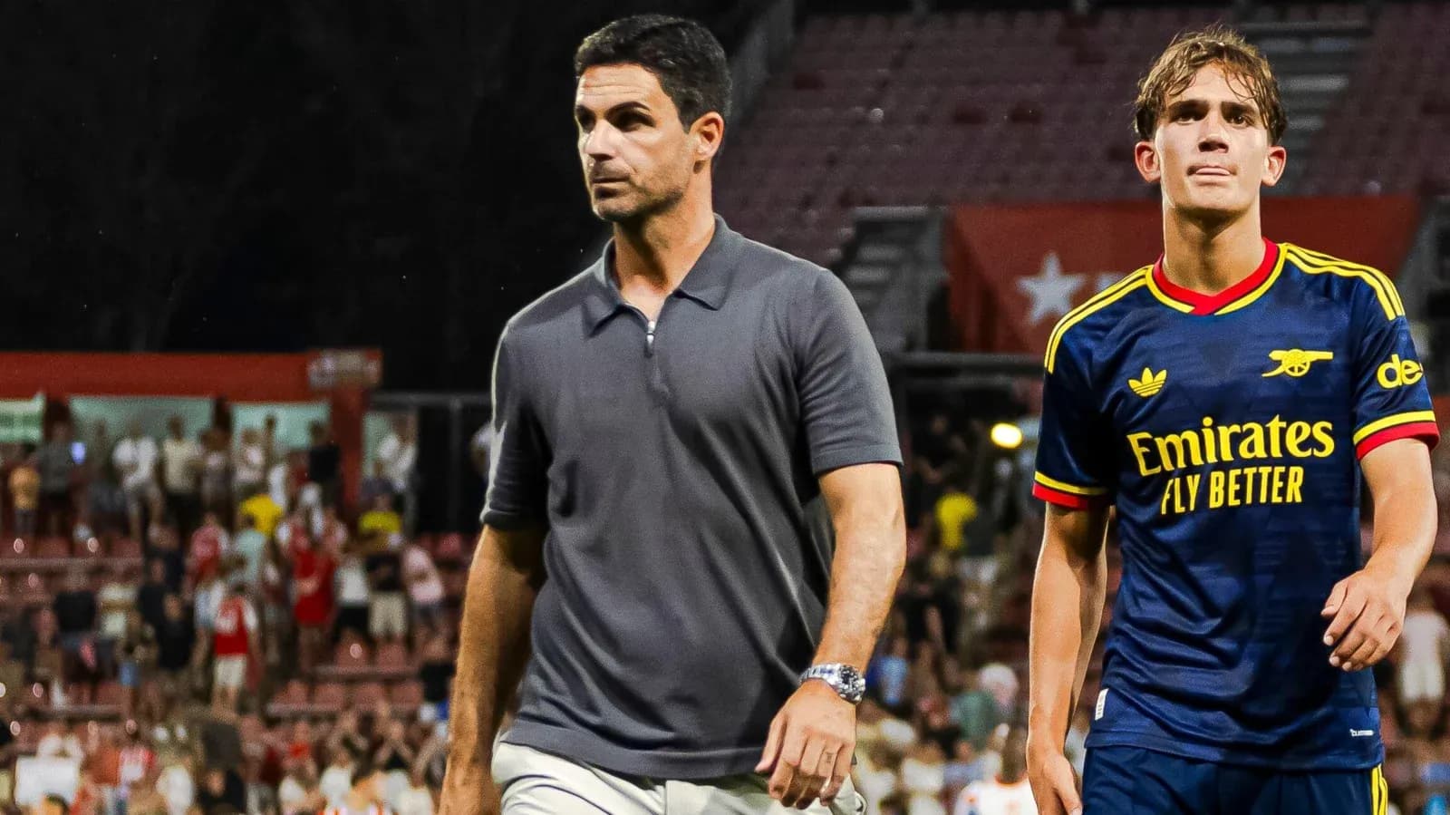 Entrenador y jugador de Arsenal caminando en el campo