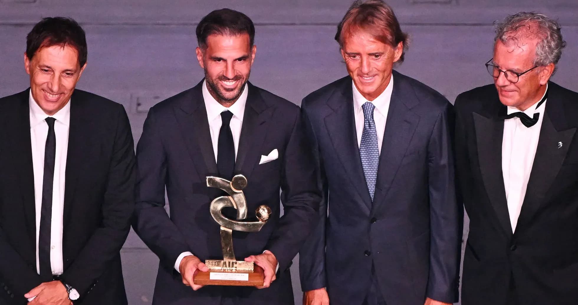 Cuatro hombres en un evento con un trofeo Cuatro hombres en un evento con un trofeo