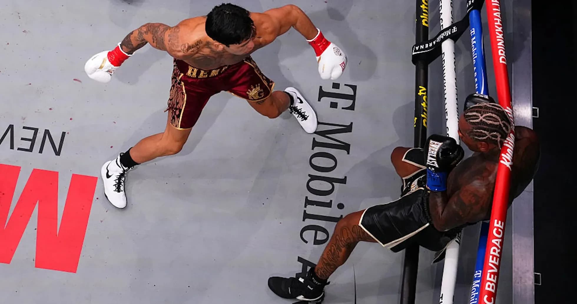 Boxer throwing a punch at opponent in ring Boxer throwing a punch at opponent in ring