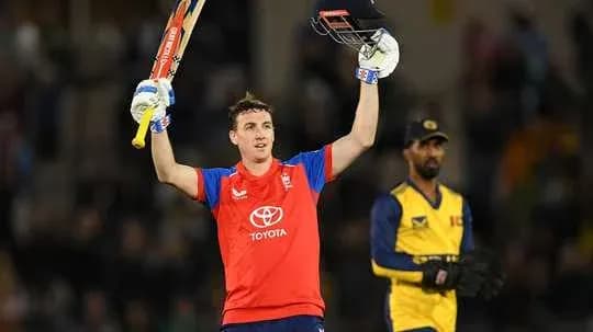 Jugador de cricket celebrando con bate levantado Jugador de cricket celebrando con bate levantado
