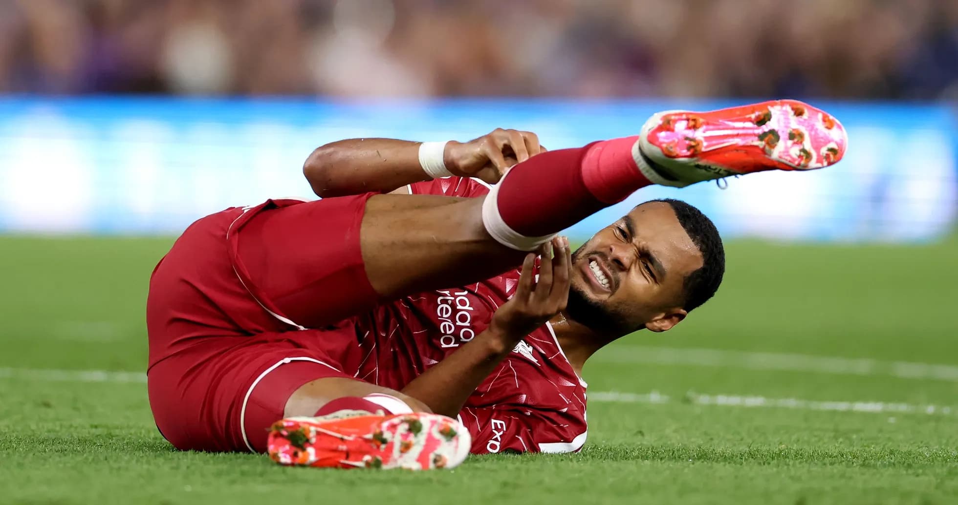 Jugador de Liverpool en el suelo con una lesión Jugador de Liverpool en el suelo con una lesión
